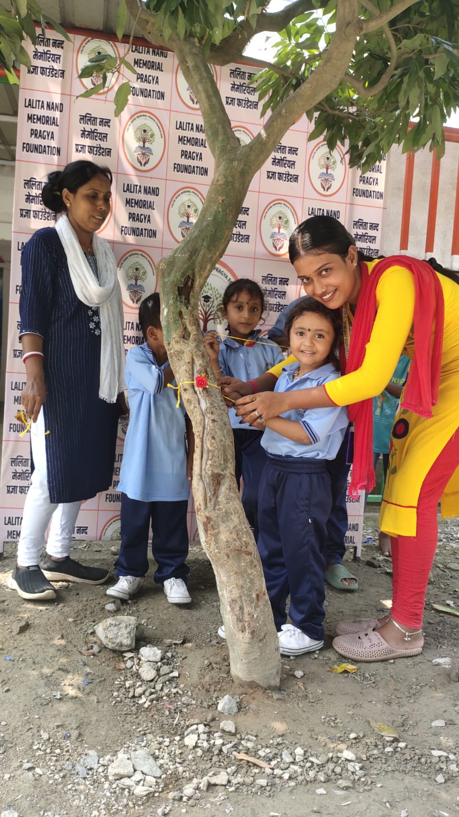 Children tie a protective thread around a tree
